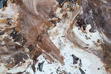 the wall is stained with brown and white paint