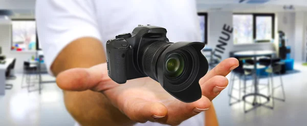 Young man using modern camera — Stock Photo, Image