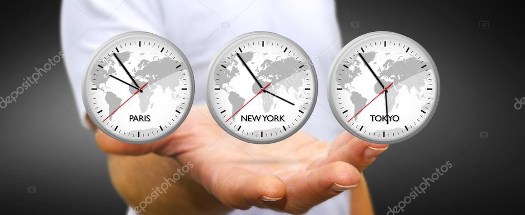 Businessman holding time of the world in his hand