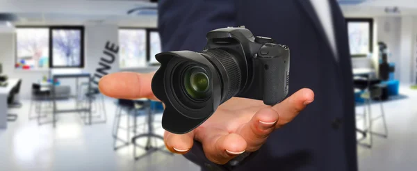 Young man using modern camera — Stock Photo, Image