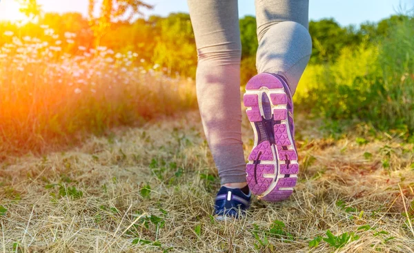 Donna che corre al tramonto in un campo — Foto Stock