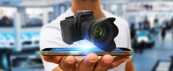 Young man using modern camera — Stock Photo, Image