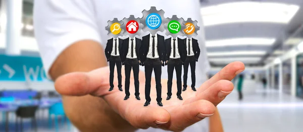 Man holding Group of businessmen in his hand with application ic — Stock Photo, Image