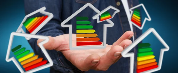 Businessman holding 3D eco house and energy efficiency — Stock Photo, Image