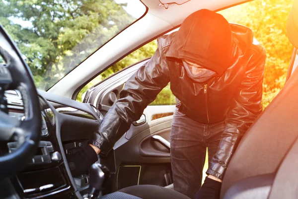 Thief stealing a car Stock Picture