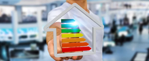 Businessman holding 3D eco house and energy efficiency — Stock Photo, Image