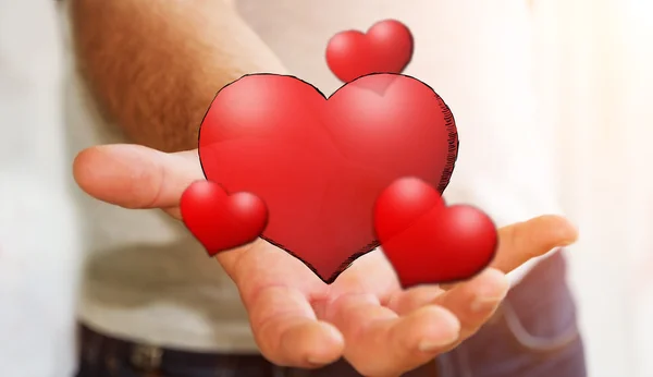 Young man holding hand drawn red heart — Stock Photo, Image