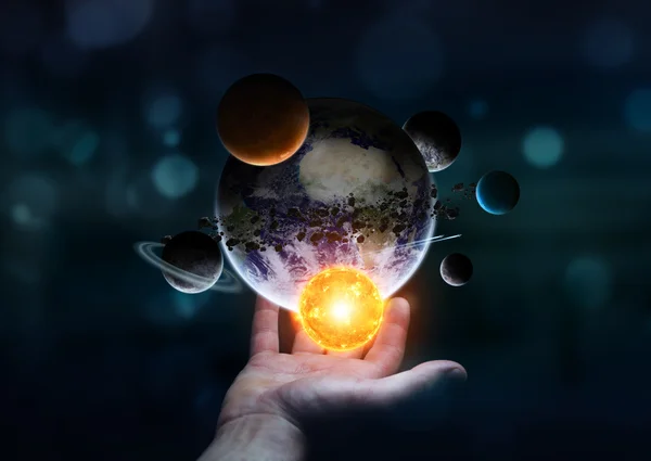 Businessman holding solar system in his hand 'elements of this image furnished by NASA' — ストック写真