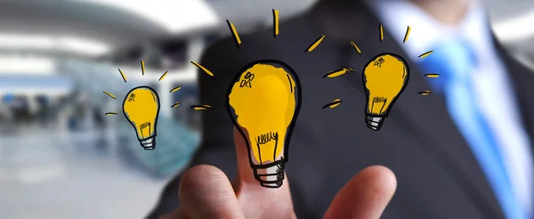 Businessman touching hand drawn lightbulb — Stock Photo, Image
