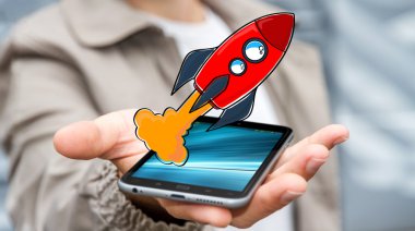 Kırmızı el çekilmiş roket onun cep telefonu üzerinde tutan işadamı