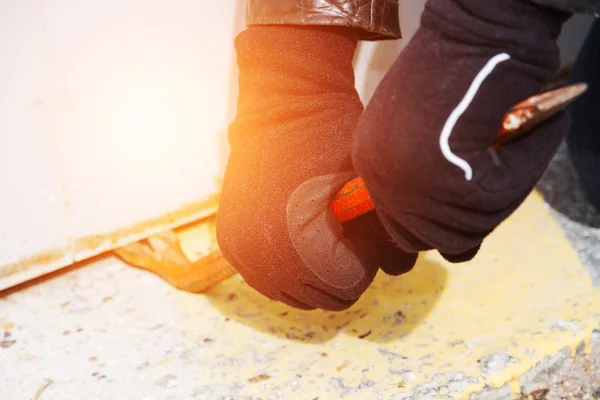 Burglar wearing leather coat breaking in a house — Stock Photo, Image