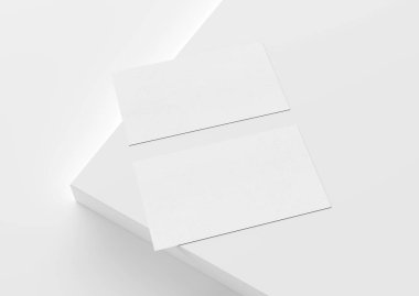 Beyaz arka planda iki beyaz Amerikan kartviziti. Önde ve arkada boş bir yüzey üzerinde duran Amerikan büyüklüğünde bir kartvizit.