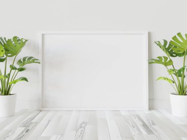 Beyaz çerçeve, iç kısımda, bitkilerin maketi ile birlikte yere dayanıyor. 3 boyutlu bir resimde çerçevelenmiş bir resmin şablonu