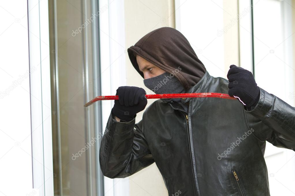 Burglar breaking in a house