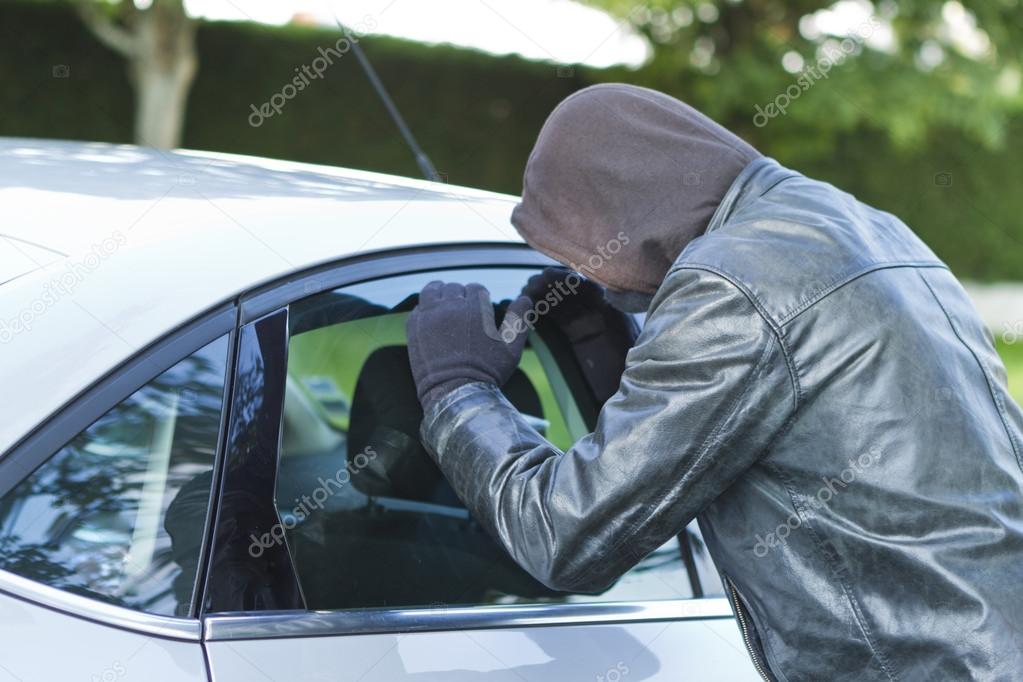 Thief stealing a car