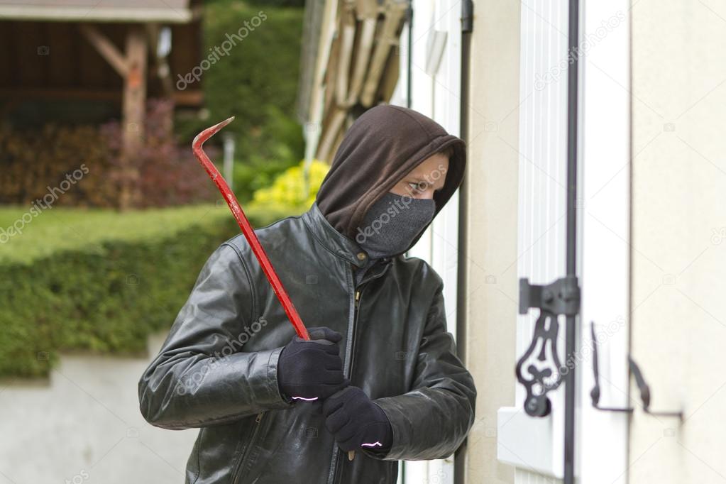 Burglar breaking in a house