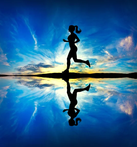 Running girl at sunset silhouette Royalty Free Stock Photos