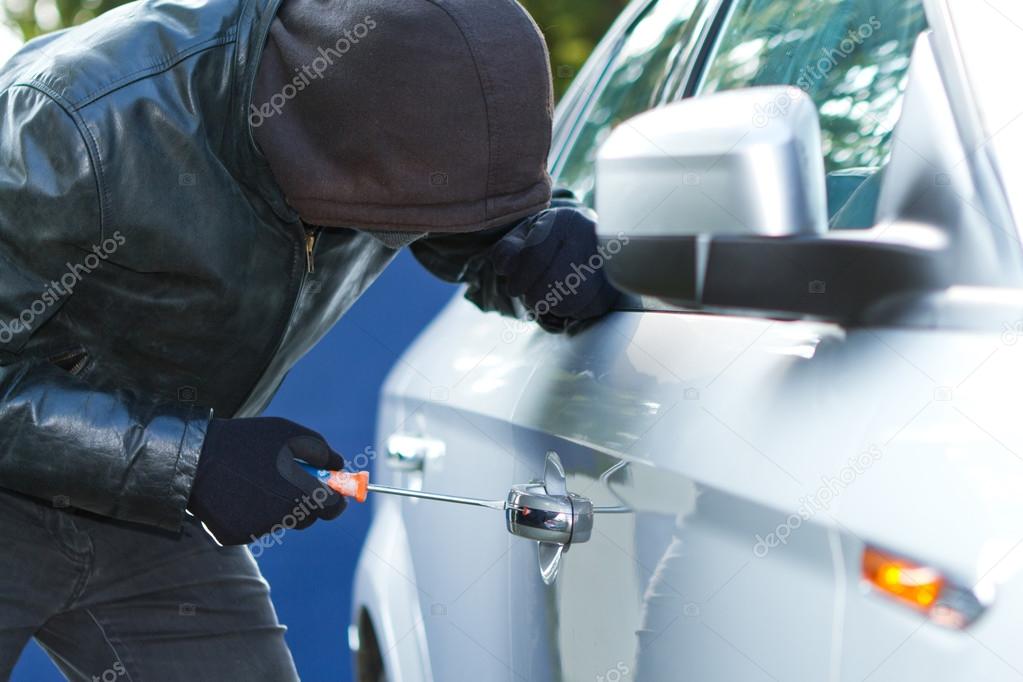 Thief stealing a car