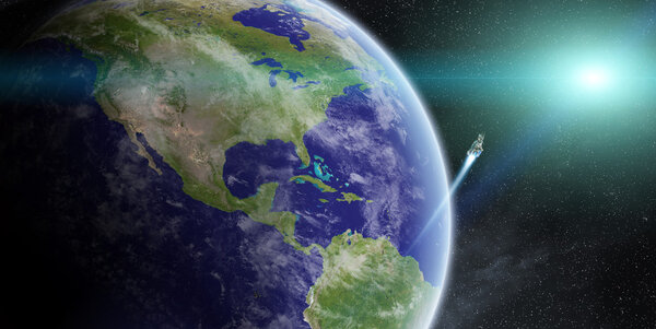 Восход солнца над планетой Земля в космосе
