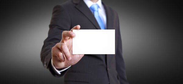 Businessman holding business card