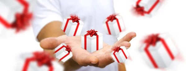 Man celebrating christmas holding gift in his hand — Stock Photo, Image
