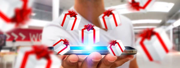 Man celebrating christmas holding gift in his hand — Stock Photo, Image