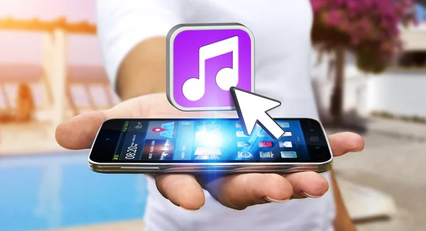 Young man using modern mobile phone to listen music — Stock Photo, Image