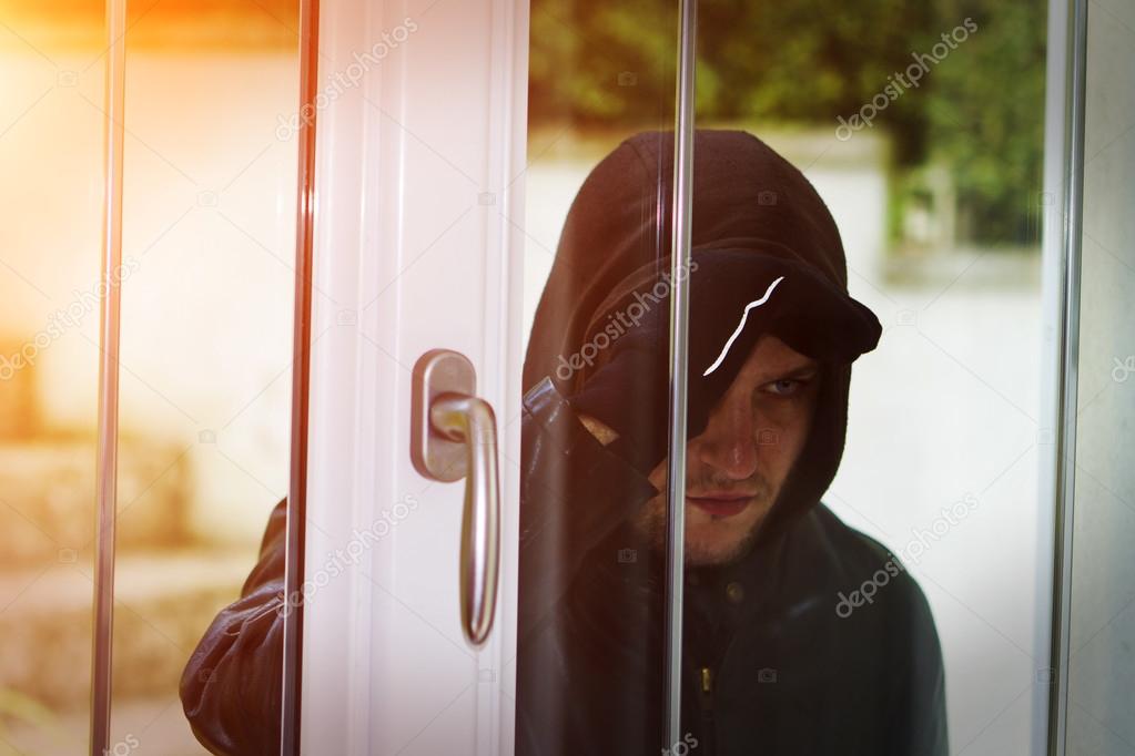 Burglar breaking in a house