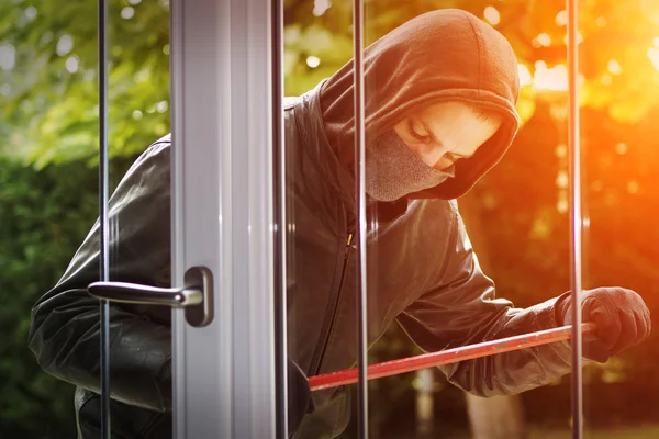 Inbreker breken in een huis — Stockfoto