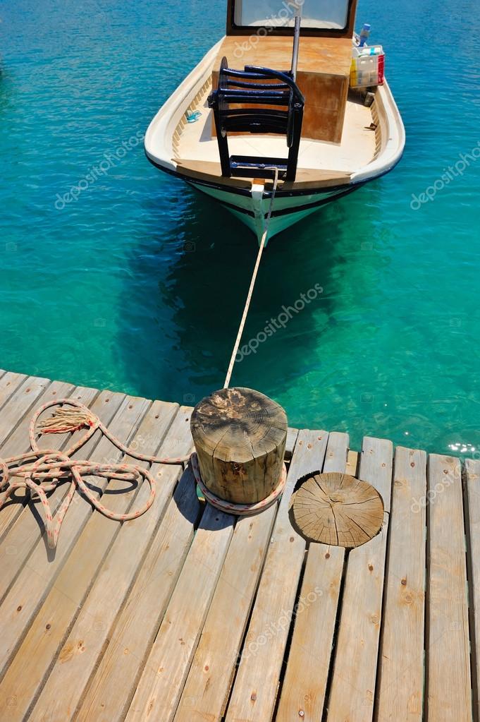 Boat rope tied to a wooden pole on the pier — Stock Photo © NataliiaMelnyc  #114057194