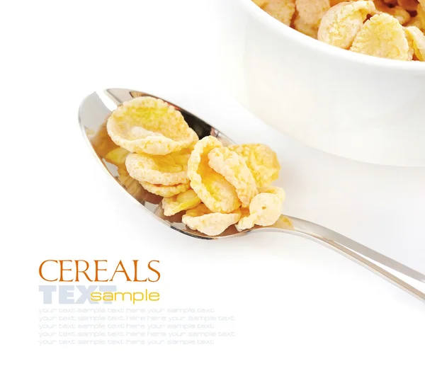 Cornflakes in spoon on white background — Stock Photo, Image