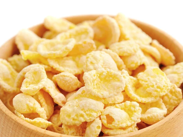 Cornflakes dalam mangkuk kayu pada latar belakang putih — Stok Foto