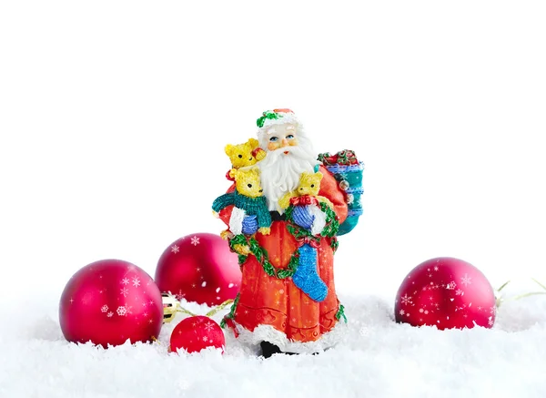 Santa Claus met kerstversiering op sneeuw — Stockfoto