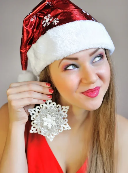 Attractive young woman holding christmas decoration snowflake — Stock Photo, Image