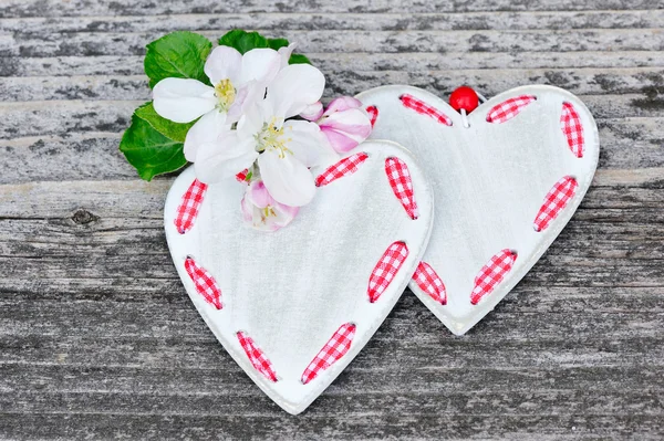 Spring Blossom and hearts over wooden background — Stock Photo, Image