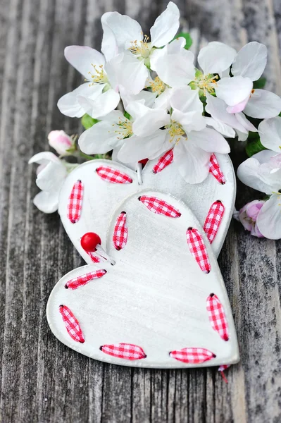 Spring Blossom and hearts over wooden background — Stock Photo, Image