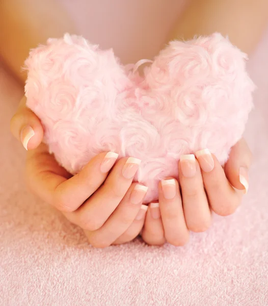 Fur pink heart in female hands — Stock Photo, Image