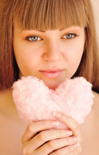 Young beautiful woman with fur heart in hands — Stock Photo, Image