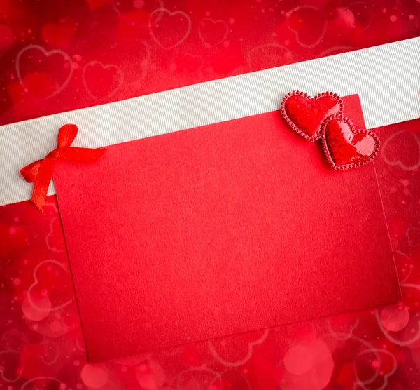Dos corazones decorativos están en la hoja de papel rojo —  Fotos de Stock