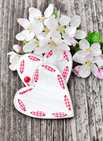 Spring Blossom and hearts over wooden background — Stock Photo, Image