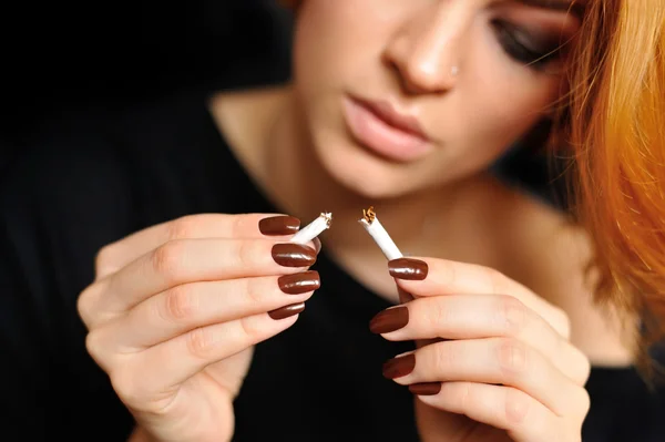 A woman breaking cigarette. concept stop smoking — Stock Photo, Image