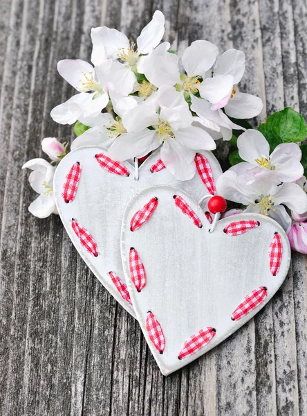 Spring Blossom and hearts over wooden background — Stock Photo, Image