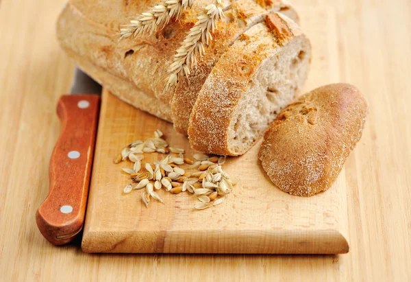 Freshly baked traditional bread on wooden board — Stock Photo, Image