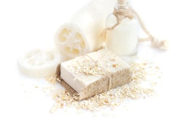 Handmade soap with oatmeal and milk on a white background clipart