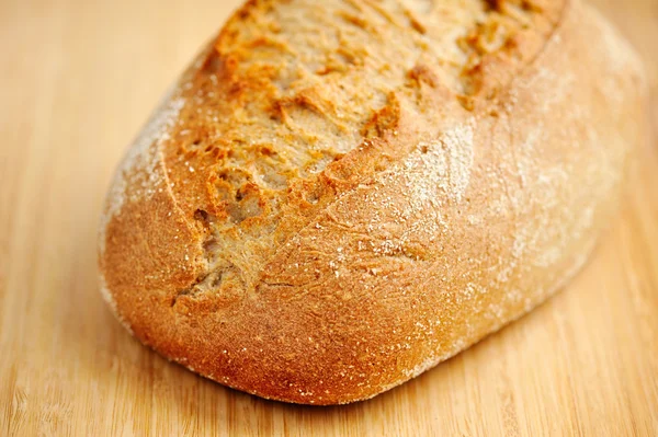 Freshly baked traditional bread on wooden board — Stock Photo, Image