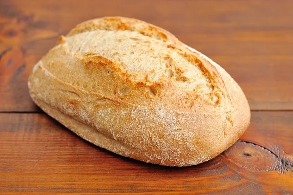 Freshly baked traditional bread on wooden board — Stock Photo, Image