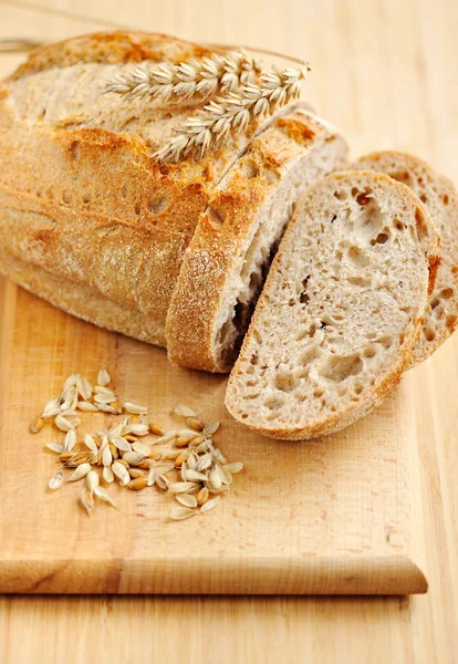 Close-up on traditional bread on wooden board — Stock Photo, Image