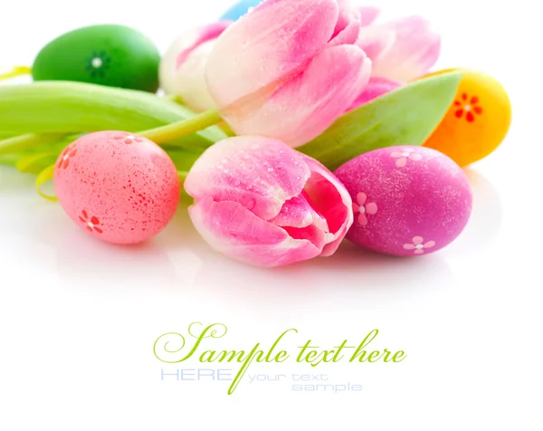 Easter eggs with pink tulip flowers on white background — Stock Photo, Image