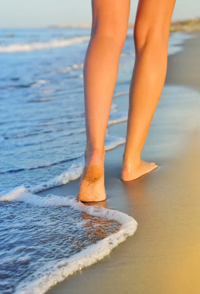 Schöne Frauenbeine, am Strand spazieren — Stockfoto