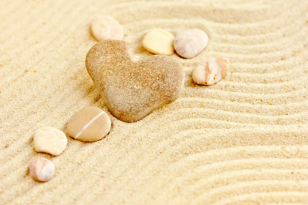 Heart shaped stone is on sand — Stock Photo, Image